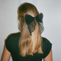 model wearing Bow Barrette in Sheer Noir in hair