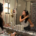 model wearing Popstar Clips in Dove Wing while using aura hair mist